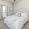 a bedroom with a fan and a bed