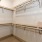 Model walk in closet at Rosalia Silverlake Senior Living Apartments in Pearland, TX, featuring shelving for storage.