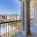 a balcony with a view of a the property and the pool