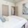 a bedroom with a ceiling fan and a bed